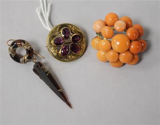 A Victorian gold and garnet circular brooch, a similar tortoiseshell and gold pique earring and a coral brooch.